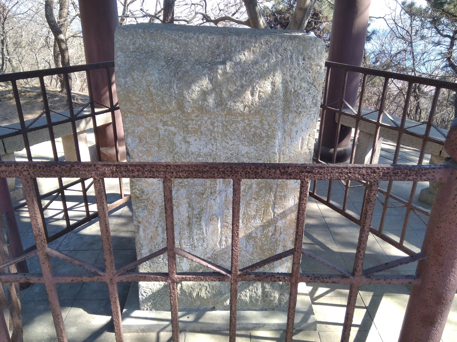 The Qin Langya inscription stone at Langya Terrace, the ancient stone standing behind a railing in its pavilion